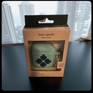 This is a Blue Kate Spade New York Spade Flower Silicone AirPods Case.